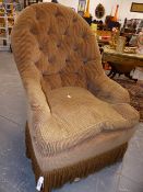 A VICTORIAN STYLE BUTTON BACK ARMCHAIR OF GENEROUS PROPORTIONS.