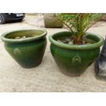 A PAIR OF GLAZED LARGE GARDEN PLANTERS AND A DEMI LUNE GARDEN SEAT.