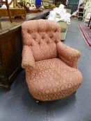 A VICTORIAN BUTTON BACK ARMCHAIR ON TURNED FORELEGS.