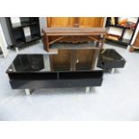 A BLACK LACQUER COFFEE TABLE AND MATCHING TV STAND.