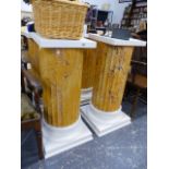 A SET OF FOUR FAUX MARBLE DISPLAY COLUMNS.