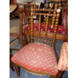 A VICTORIAN NURSING CHAIR WITH BOBBIN BACK.