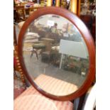 AN EDWARDIAN INLAID OVAL MIRROR.