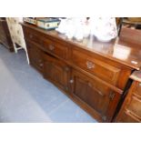 A BESPOKE OAK DRESSER BASE WITH THREE DRAWERS AND THREE DOORS.