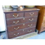 A GEORGIAN OAK CHEST OF DRAWER WITH PANELLED SIDES.