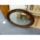 A LARGE OVAL MIRROR.