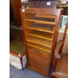 A TAMBOUR FRONT FILING CABINET.