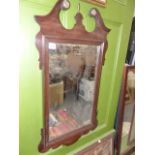 A MAHOGANY FRAMED WALL MIRROR.