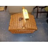 A WICKER PICNIC HAMPER.