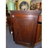 A GEORGIAN OAK CORNER CABINET.