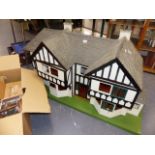 A GOOD TUDOR STYLE DOLLS HOUSE COMPLETE WITH FURNISHINGS.