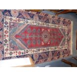 A PERSIAN PATTERN SMALL CARPET