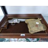 A MOUNTED COMMEMORATIVE WYATT EARP 44 REVOLVER AND AN AIR MINISTRY MARK FOUR FIRST AID OUTFIT FOR