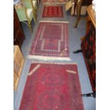 A PRAYER RUG AND TWO FURTHER SMALL RUGS.