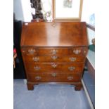 A GOOD QUALITY GEORGIAN STYLE OAK BUREAU.