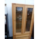 AN OAK DISPLAY CABINET.