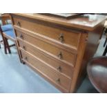 AN OAK CHEST OF DRAWERS.