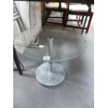 A GLASS TOP OCCASIONAL TABLE.