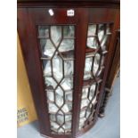 AN ANTIQUE MAHOGANY BOW FRONT ASTRAGAL GLAZED CORNER CABINET.