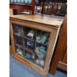 A YEW WOOD PIGEON HOLE GLAZED CABINET.
