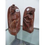 A PAIR OF CARVED BOOKENDS.