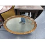 A GILT FRAMED MIRROR.