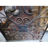 A WROUGHT IRON FIRE GUARD.