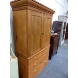 AN ANTIQUE PINE LINEN PRESS.