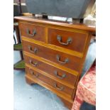 A SMALL GEORGIAN STYLE CHEST OF DRAWERS AND A THREE TIER WHATNOT.