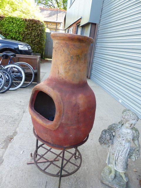 A POTTERY CHIMENEA ON STAND.