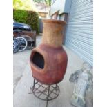 A POTTERY CHIMENEA ON STAND.