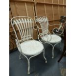A PAIR OF FRANCOIS CARRE SPRUNG BACK WROUGHT IRON GARDEN OR CAFE CHAIRS.