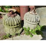 A PAIR OF ANTIQUE CARVED STONE FINIALS WITH IRON LEAF KNOPS.