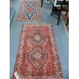 AN ANTIQUE PERSIAN HAMADAN RUG. 129 x 75cms TOGETHER WITH A SHIRAZ RUG OF SIMILAR SIZE. (2).`