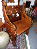 A LATE VICTORIAN GOTHIC REVIVAL OAK HALL SEAT WITH CARVED PIERCED BACK.