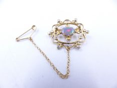 AN 18ct YELLOW GOLD, LIGHTNING RIDGE, BLACK OPAL AND DIAMOND BROOCH IN A FILIGREE SETTING. THE