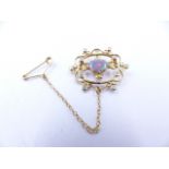 AN 18ct YELLOW GOLD, LIGHTNING RIDGE, BLACK OPAL AND DIAMOND BROOCH IN A FILIGREE SETTING. THE