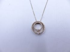 A 9ct YELLOW GOLD DOUBLE DIAMOND HALO PENDANT. TWO HALOS OF DIAMONDS ARE NESTED TOGETHER AND