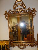 A LARGE CARVED GILTWOOD ITALIAN BAROQUE STYLE MARGINAL MIRROR. 184 x 124cms.