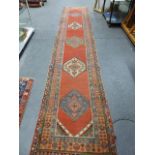 AN ANTIQUE PERSIAN TRIBAL RUNNER. 530 x 100cms.