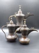 A SCARCE SET OF THREE VINTAGE TURKISH COPPER COFFEE POTS OF GRADUATED SIZE DECORATED WITH BANDS OF