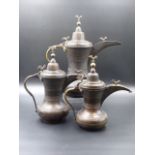 A SCARCE SET OF THREE VINTAGE TURKISH COPPER COFFEE POTS OF GRADUATED SIZE DECORATED WITH BANDS OF