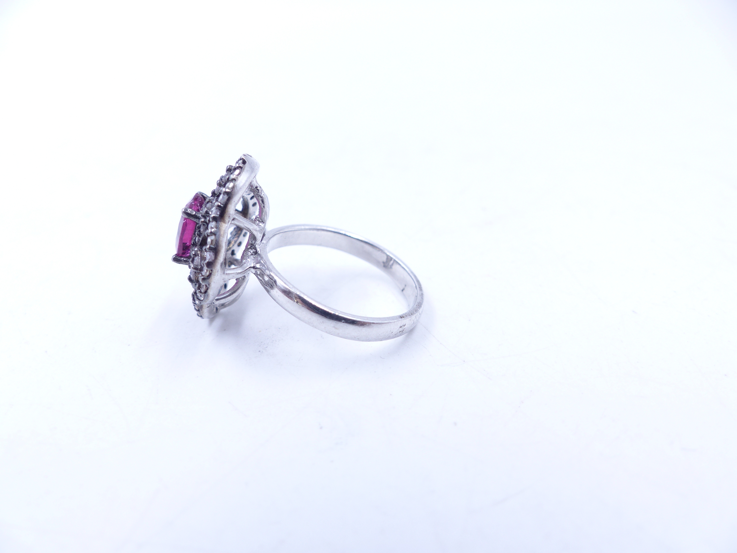 A PINK TOURMALINE AND DIAMOND OPEN WORK FILIGREE RING SET IN A WHITE METAL MOUNT,THE CENTRAL PINK - Image 3 of 17