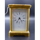 A 20th.C.GILT BRASS CARRIAGE CLOCK WITH WHITE ENAMEL DIAL SIGNED ASPREY.