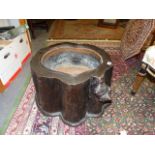 AN INTERESTING ORIENTAL NATURALISTIC CAMPHORWOOD STUMP WITH INSET IRON AND COPPER JARDINIERE.