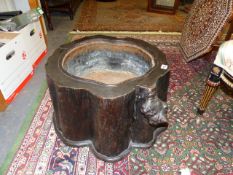 AN INTERESTING ORIENTAL NATURALISTIC CAMPHORWOOD STUMP WITH INSET IRON AND COPPER JARDINIERE.