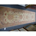 AN ORIENTAL RUNNER OF ZIEGLER DESIGN. 244 x 77cms.