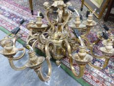 A HEAVY GILT BRASS EIGHTEEN LIGHT BAROQUE STYLE CHANDELIER, SCROLL ARMS WITH PUTTO MASK DECORATED