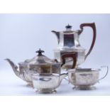 A FOUR PIECE SILVER SERVICE COMPRISING OF A PRESENTATION ENGRAVED TEA POT, COFFEE POT, SUGAR AND