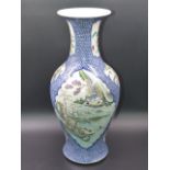 A CHINESE BLUE AND WHITE BALUSTER FORM VASE WITH FAMILLE ROSE CARTOUCHE PANELS OF FIGURES, FLOWERS